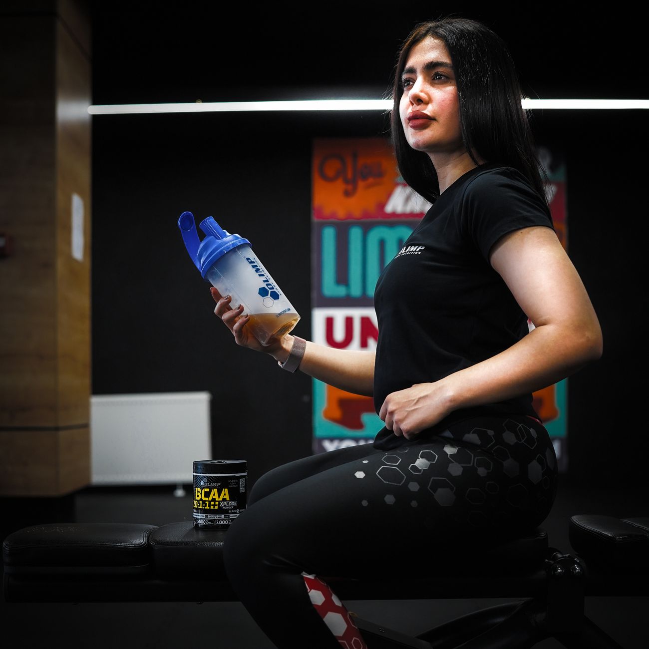 woman sitting on bench at gym